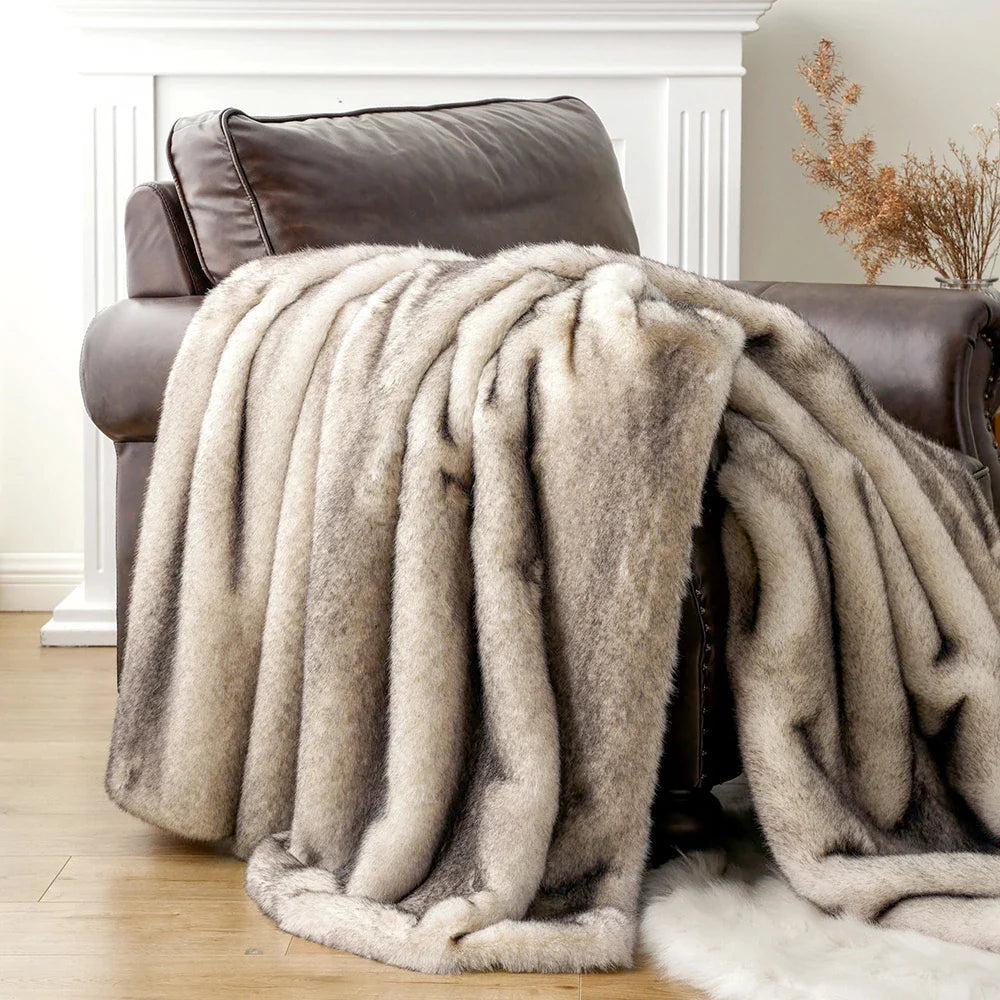 Beige blanket draped over a brown armchair in a cozy living room setting.