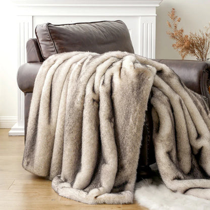 Beige blanket draped over a brown armchair in a cozy living room setting.