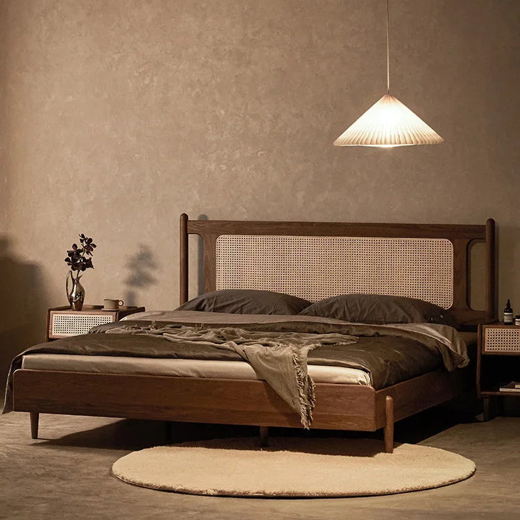 Wooden bed with wicker headboard in a dimly lit room