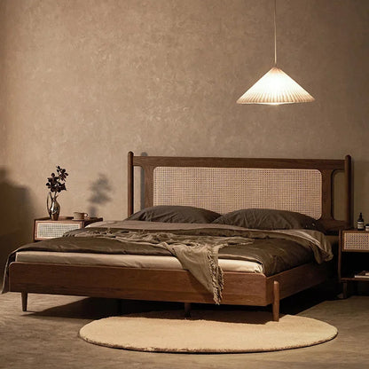 Wooden bed with wicker headboard in a dimly lit room