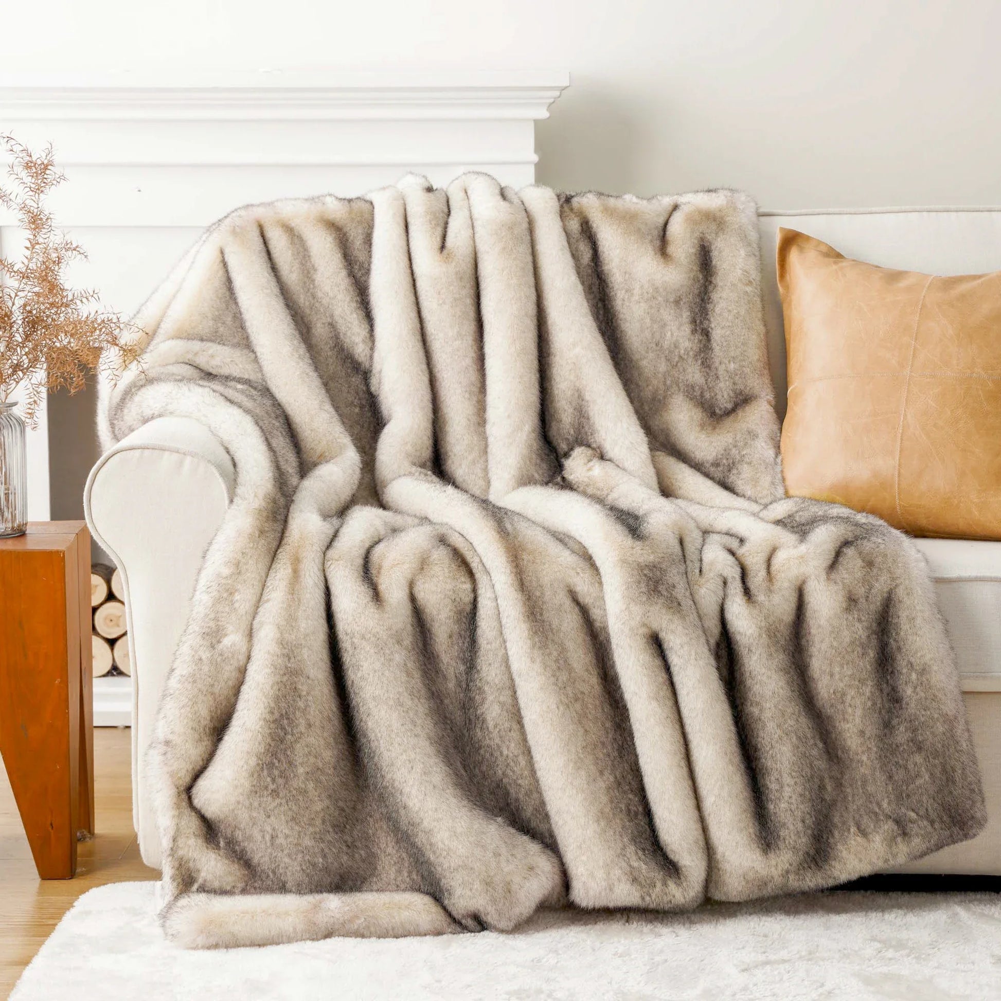 Fluffy beige blanket draped over a sofa in a cozy living room setting.