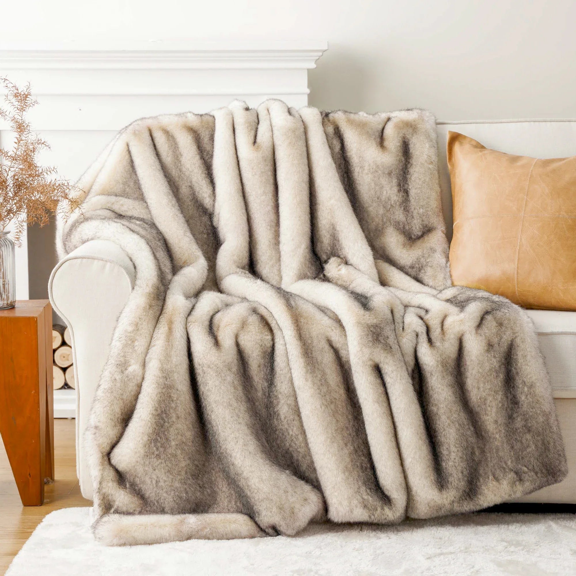Fluffy beige blanket draped over a sofa in a cozy living room setting.
