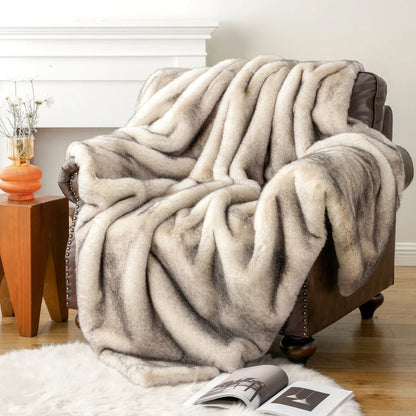 Fluffy beige blanket draped over a brown armchair in a cozy living room.