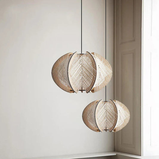 Woven pendant lights hanging above a sofa in a room with neutral walls.